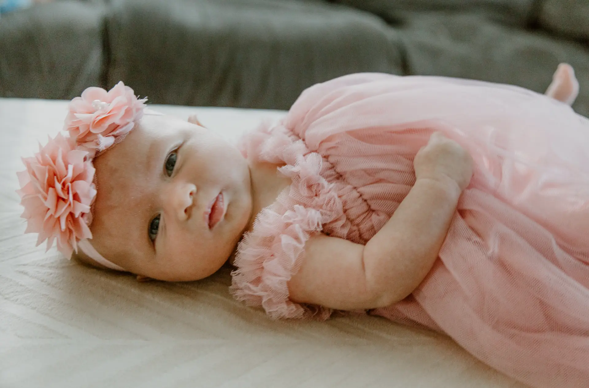 Newborn girl in pink tulle with a flower headband