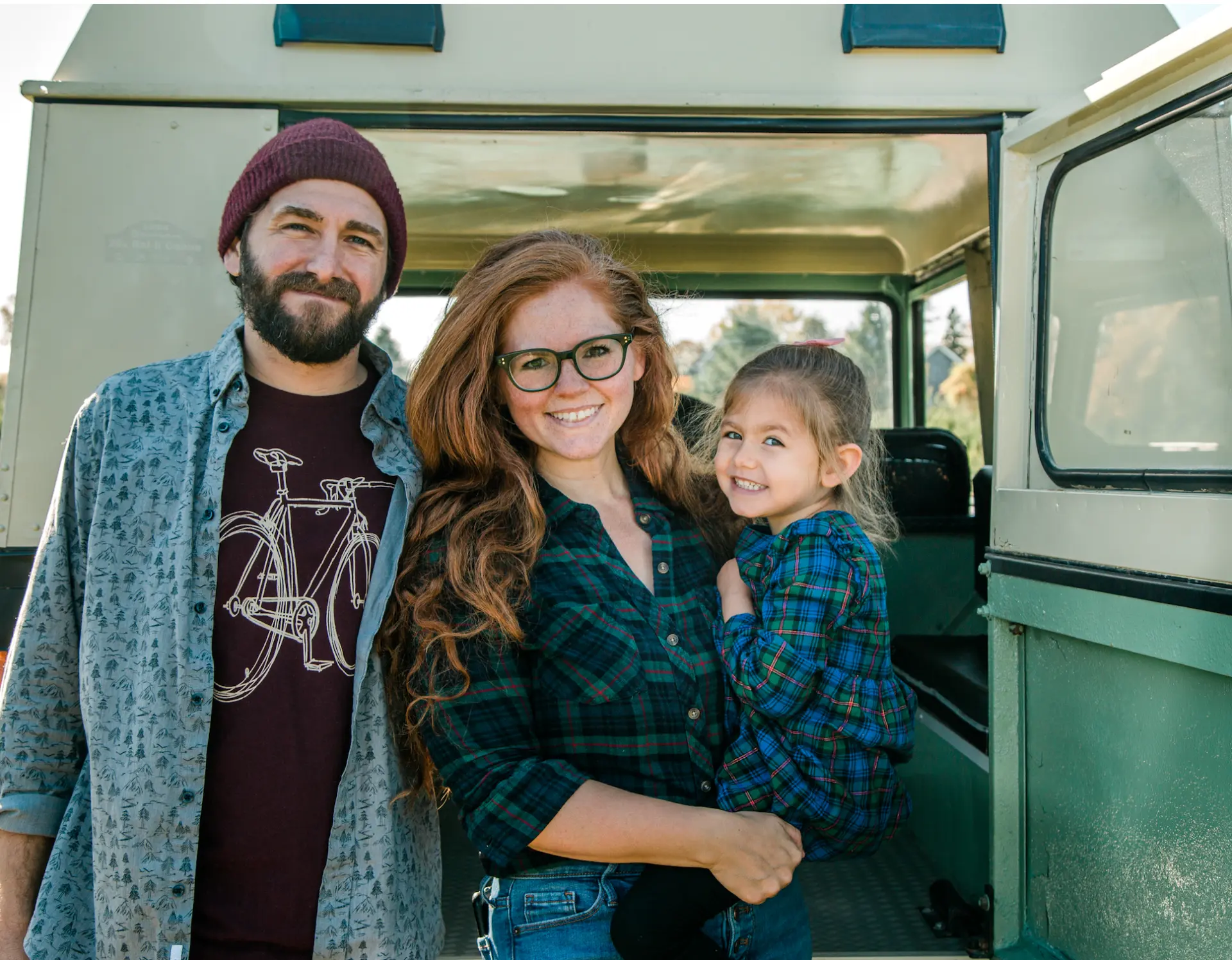 Melanie Lauren Rienzi with her husband and daughter in a vintage Land Rover